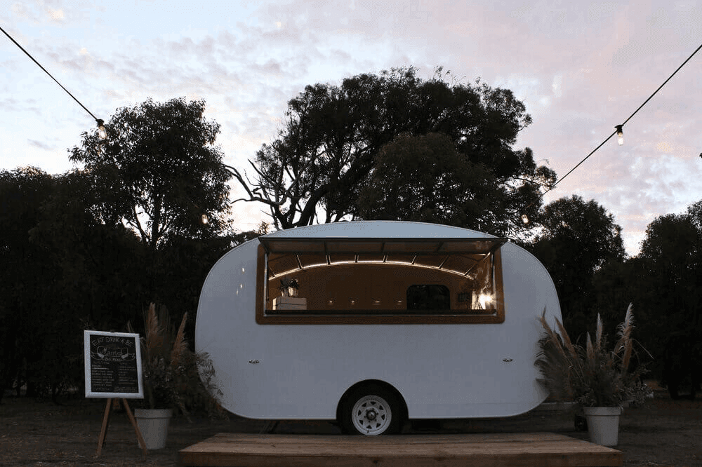 Koalabar's mobile caravan bar serving in an event.
