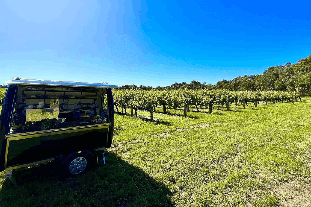 The Little Billy Cart's mobile bar catering an event in an open field located in Adelaide.