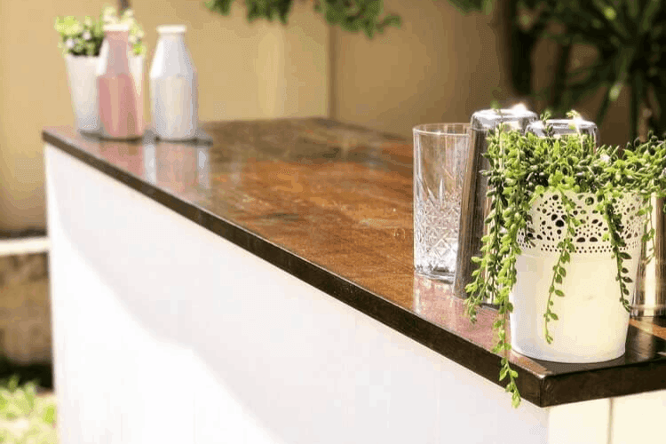 The Crafty Barman's wooden counter mobile bar with decoratives and tools for serving on top.