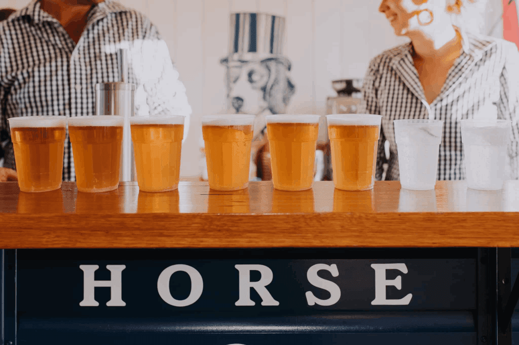 Glasses of ice cold beer served from the mobile bar of The Horse & Hound in an event.