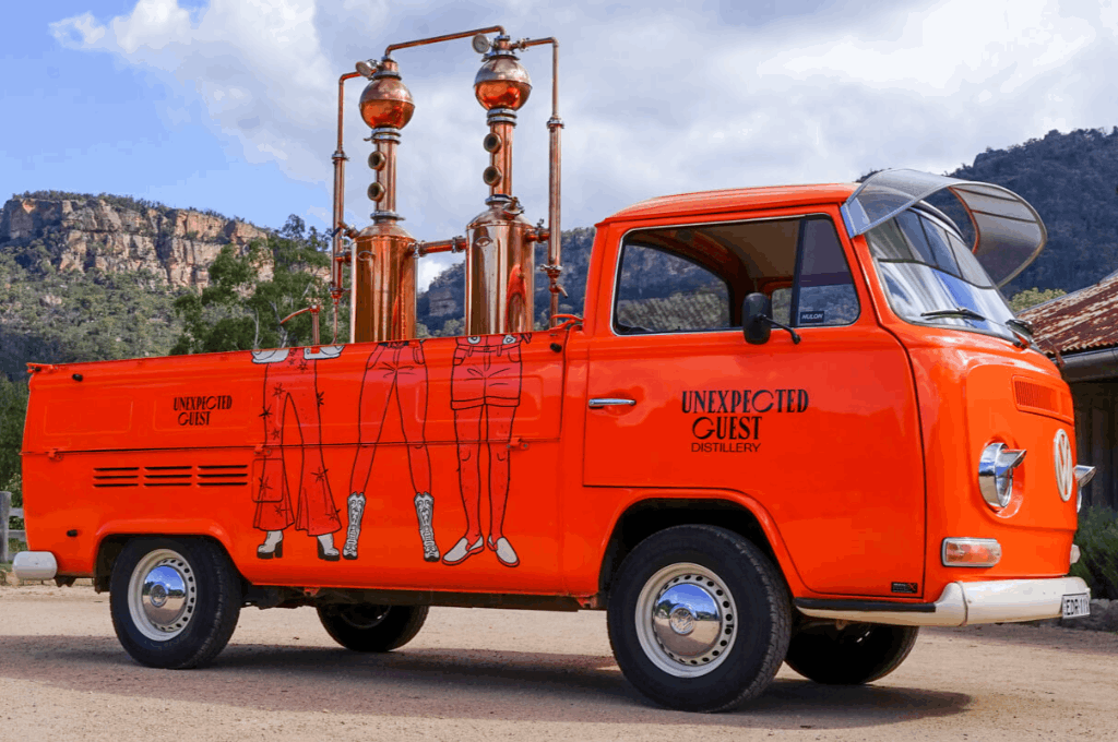 The orange kombi transformed into a mobile bar by Unexpected Guest Distillery catering an event.