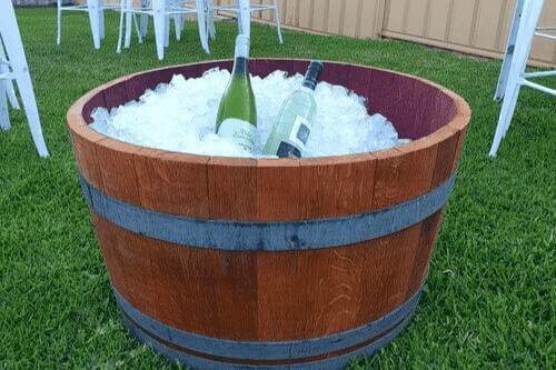 A barrel loaded with ice and two bottles of wine by the mobile bar of Your Bartender.