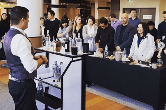 Bartender showing his skills to a live audience into mixing drinks in an event.