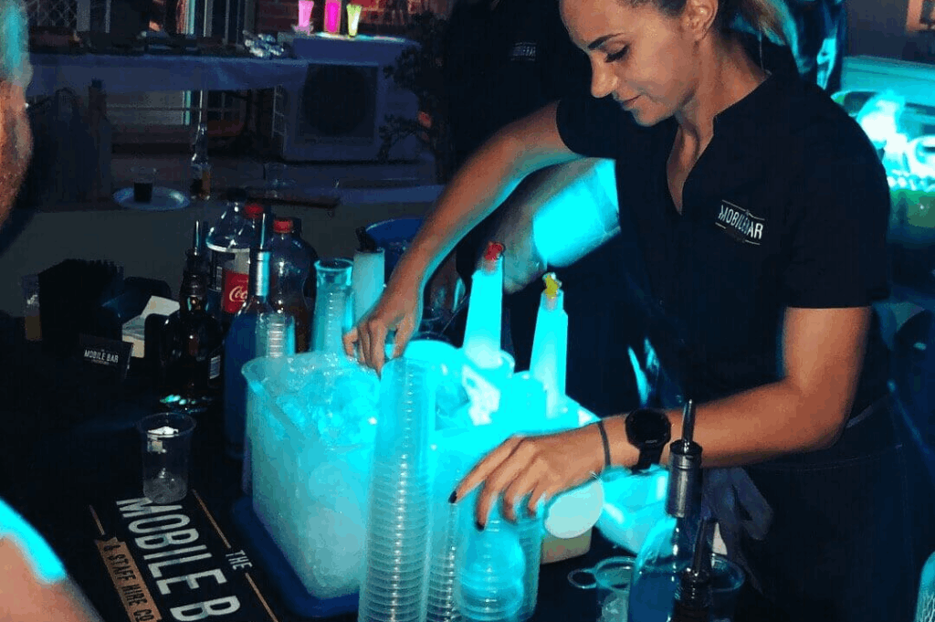 Bartenders mixing up drinks while the guest are waiting to be served.